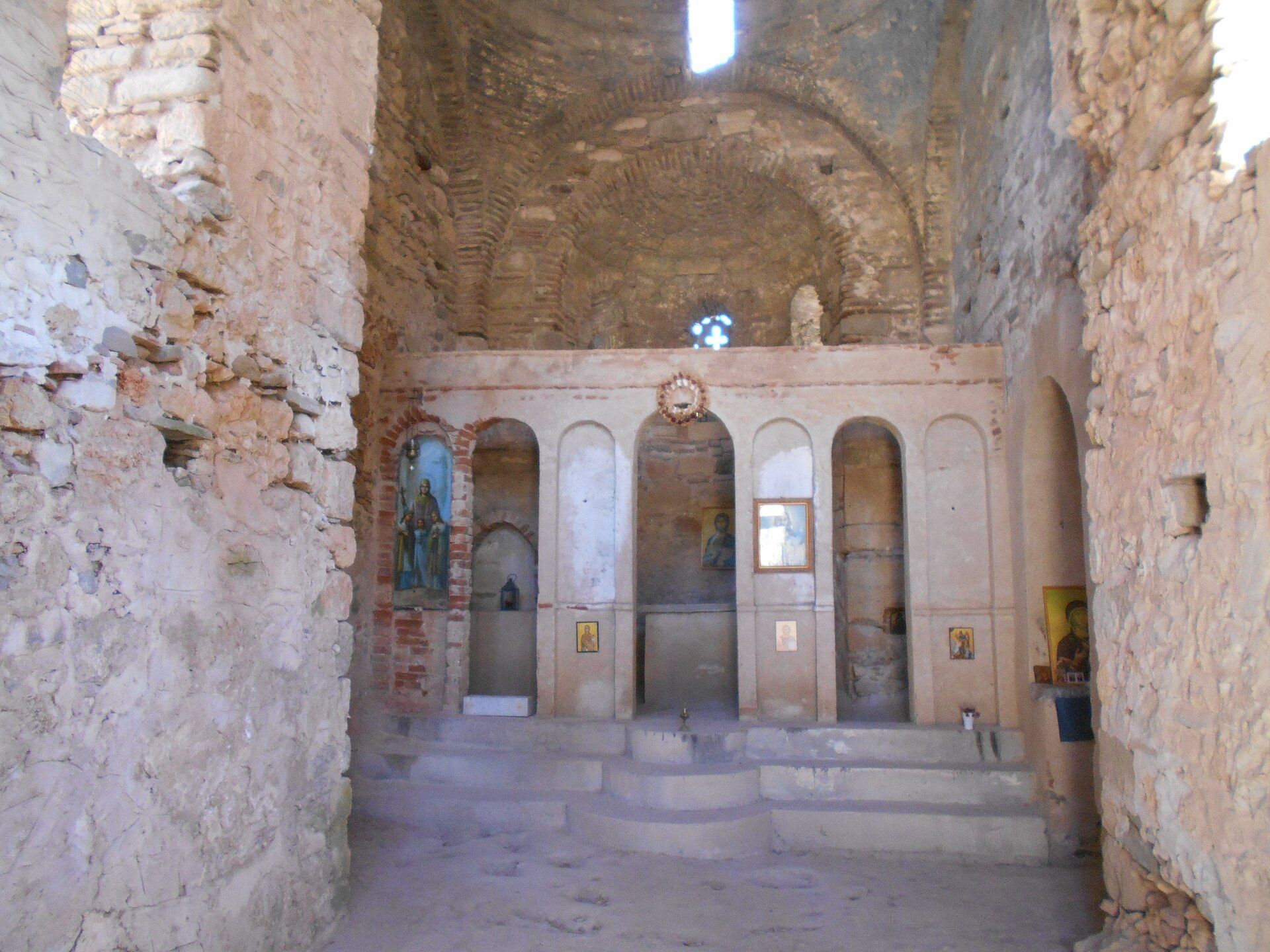 The stone interior and arches of Agia Sophia church at Koroni Castle