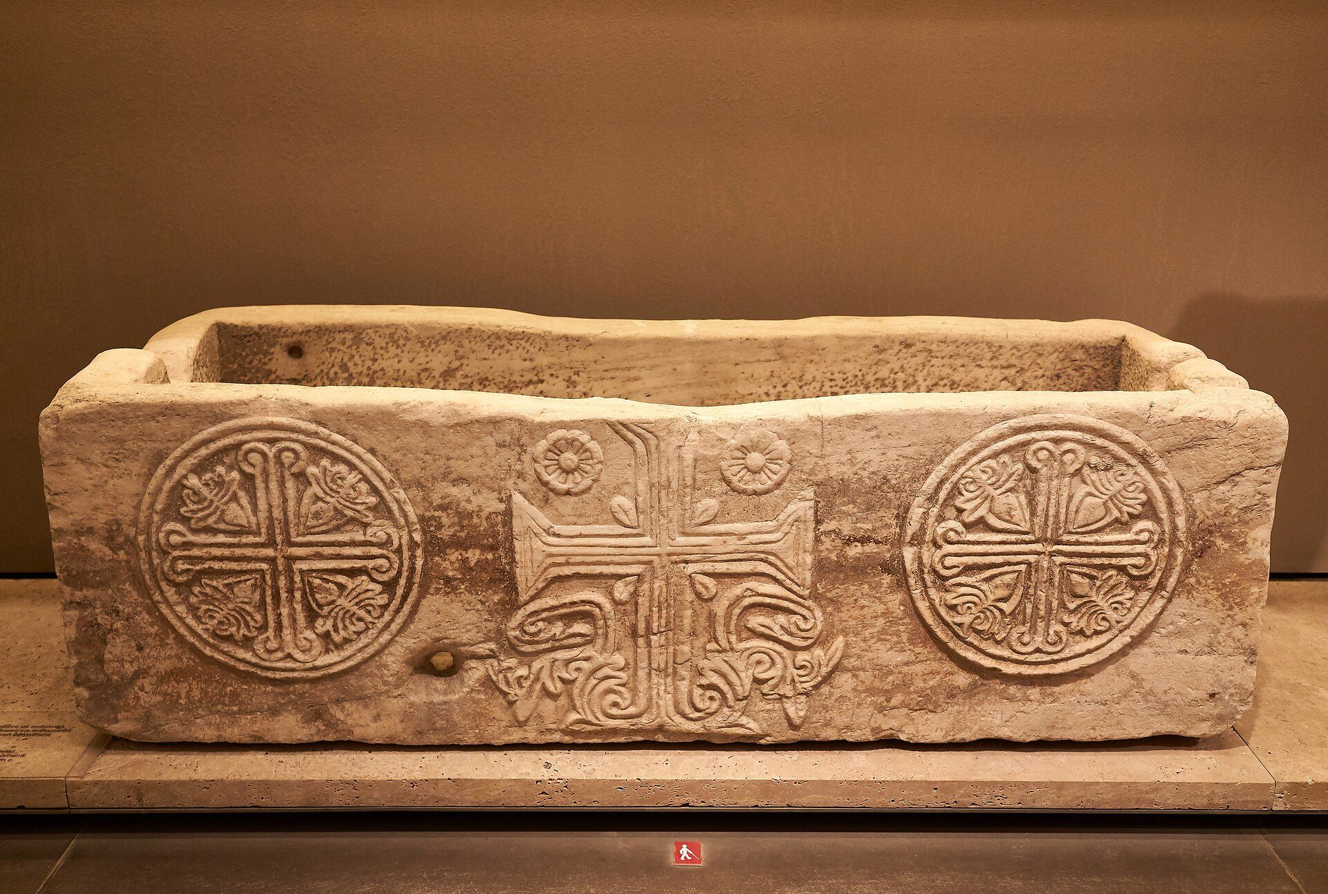 A Byzantine marble sarcophagus carved with crosses, rosettes, and palmettes