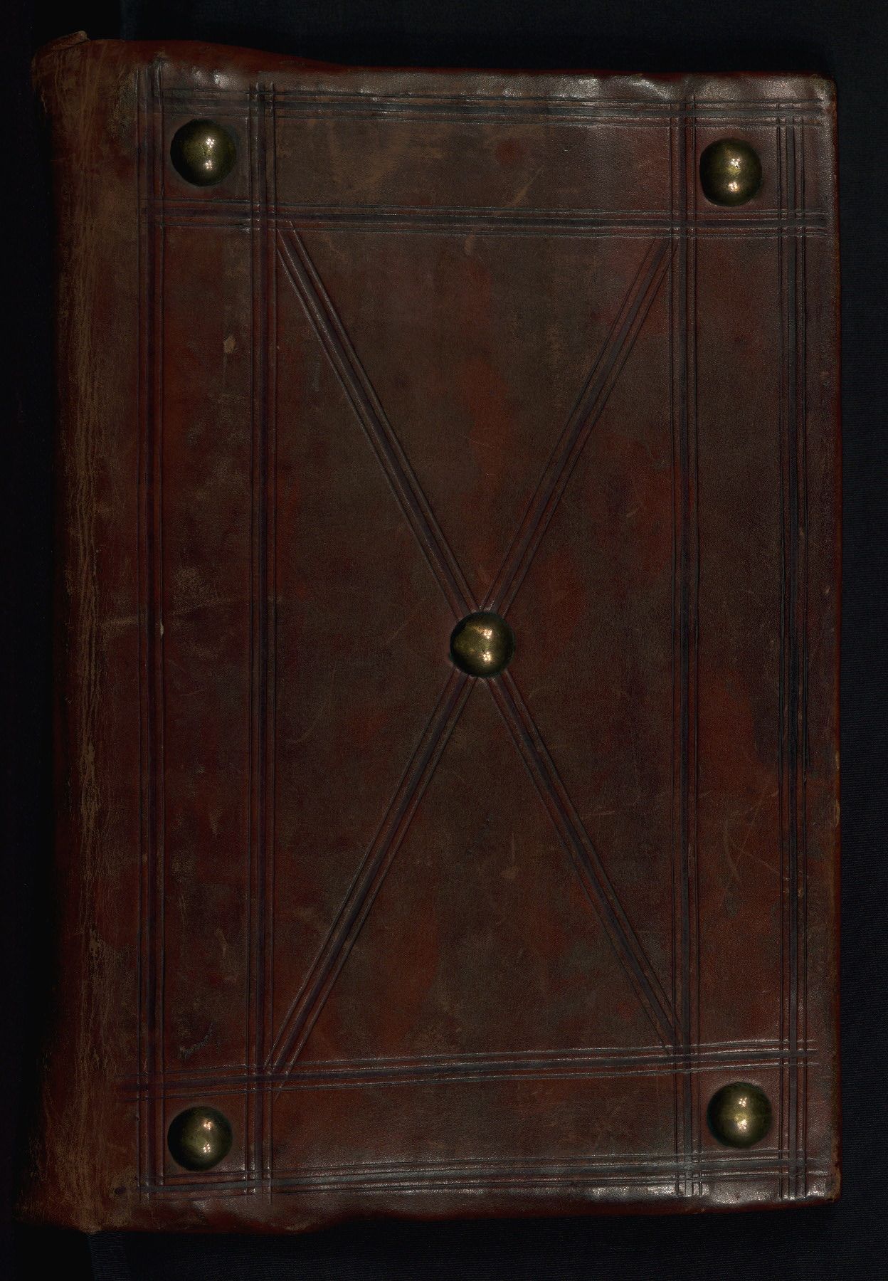 A dark tooled leather Greek Gospel binding with brass bosses